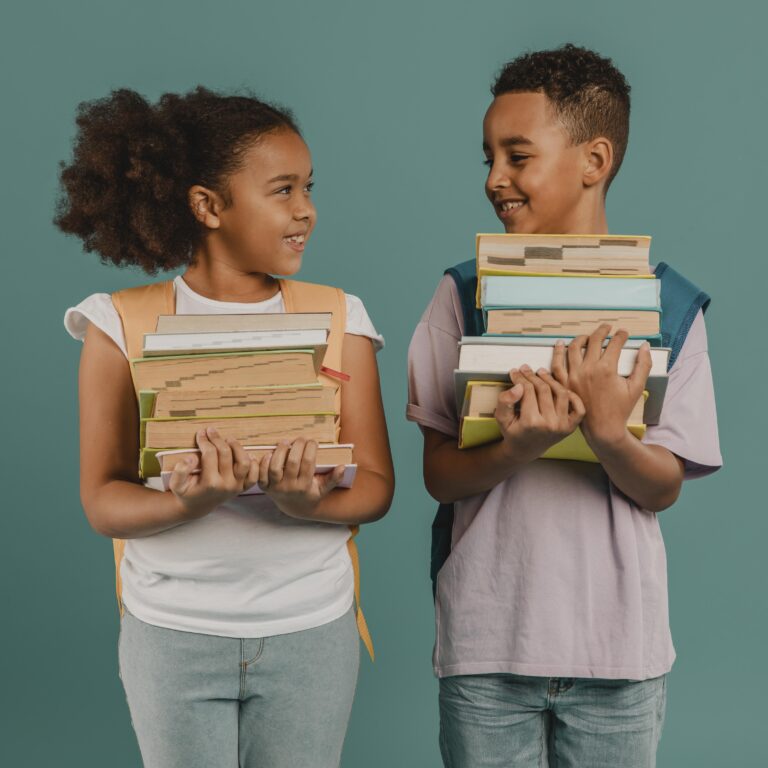 children holding piles books