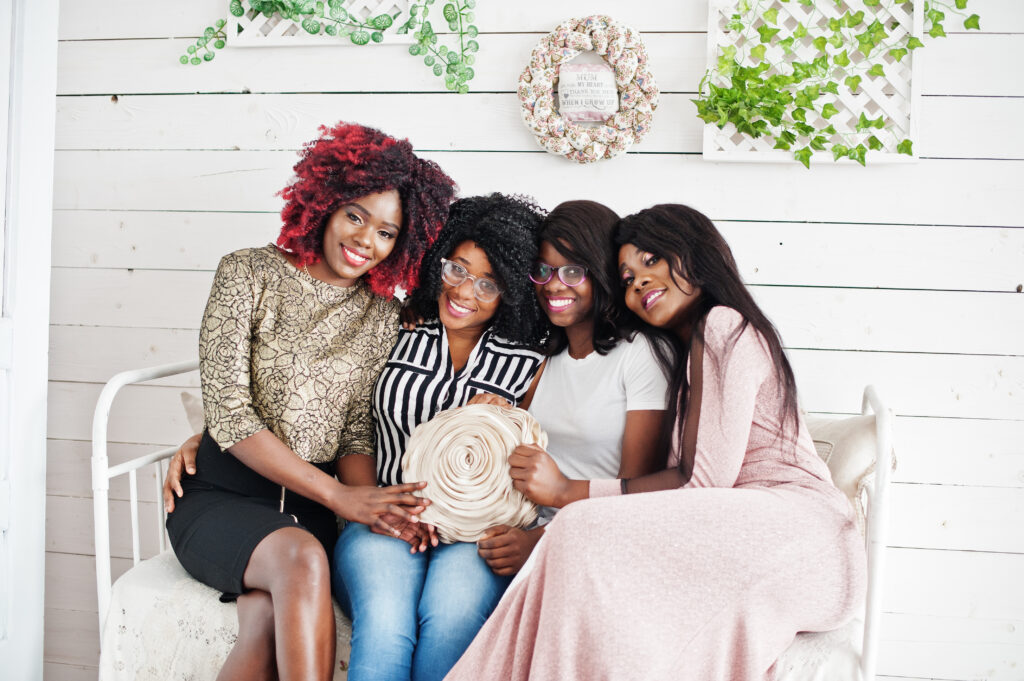 Home four best friends. young adrican women having fun, sitting on th