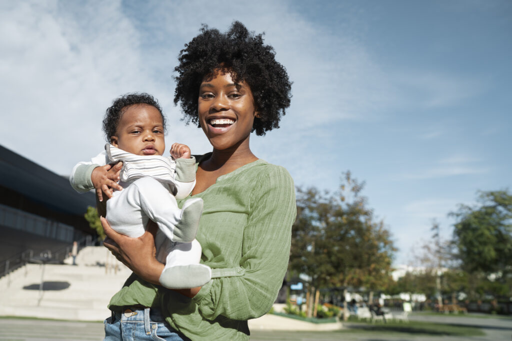 Home medium shot smiley mother holding baby